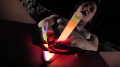 opening up her gash with glow sticks