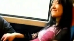 Asian milf rubs her clit on a train.