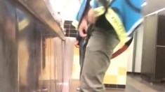 Guys in the urinals taking leak.